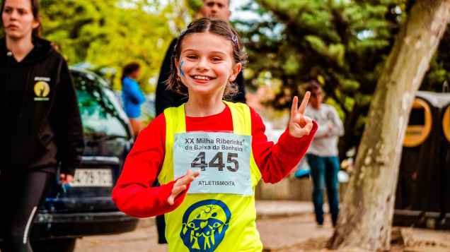 girl wearing red and yellow top running